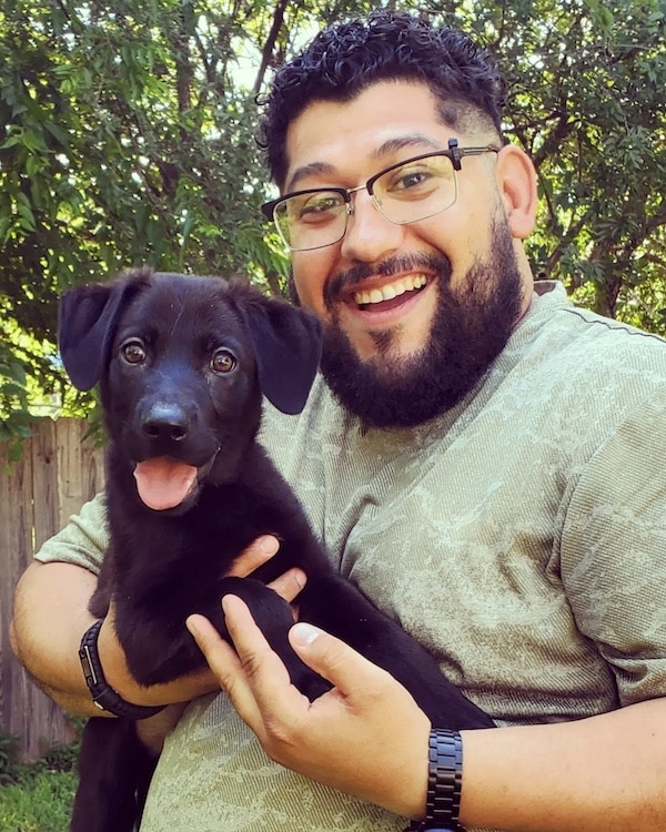 man and adopted puppy